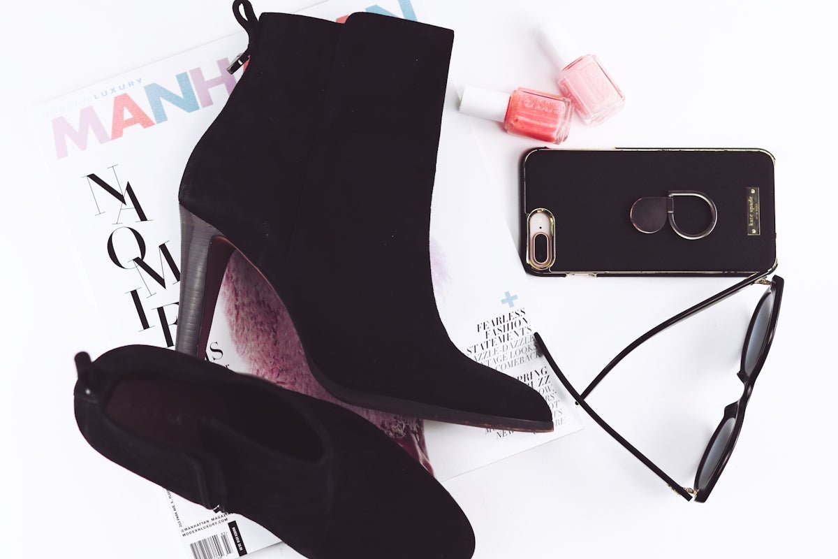 pair of black booties and iPhone 8 Plus