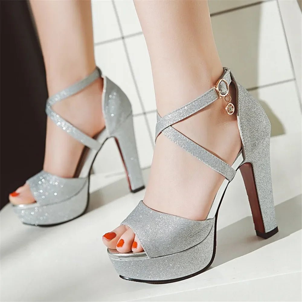 Silver glitter high-heeled shoes on a white background