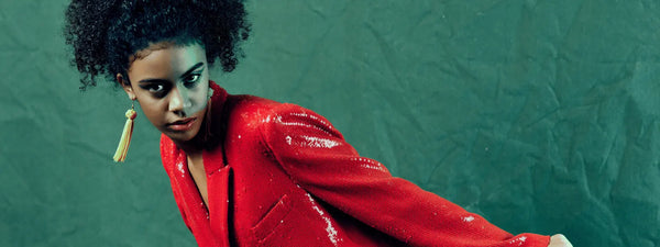 Girl wearing a red outfit against a green textured background
