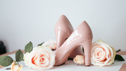 a pair of pink high heels sitting on top of a table