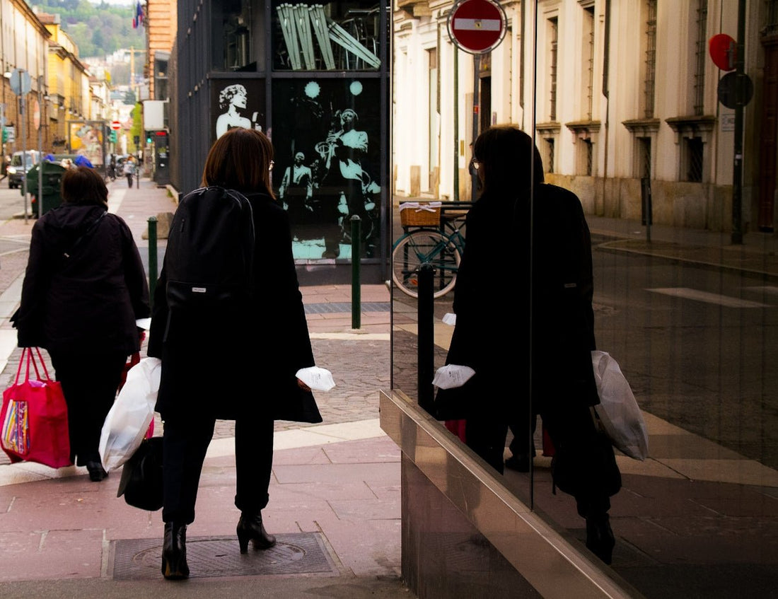 a group of people walking on a sidewalk