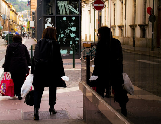 a group of people walking on a sidewalk