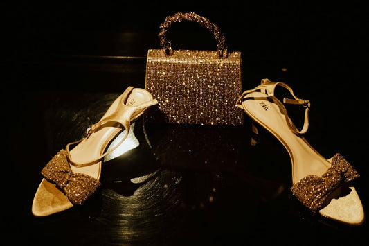 A sparkly gold handbag and matching high-heeled sandals