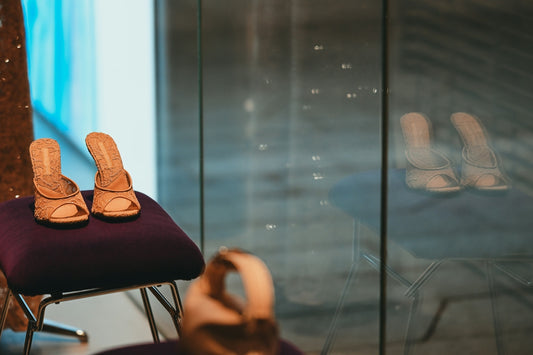 Brown high heels on a purple stool with reflections