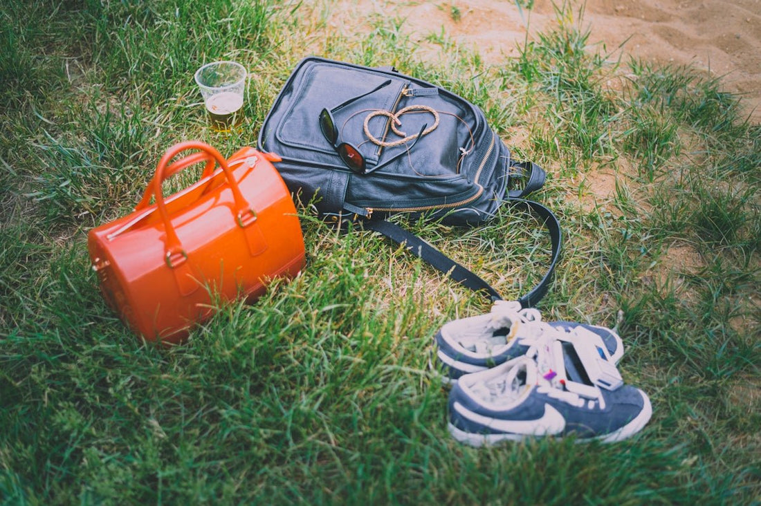 orange and black backpack on green grass field