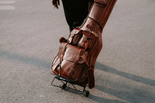 a person pushing a luggage cart down a street