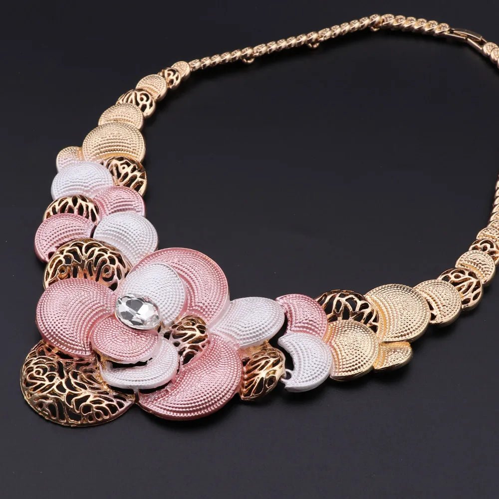 Ornate necklace with pink and gold elements on a dark background