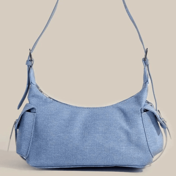 Blue fame braided accent double pocket shoulder bag on a beige background