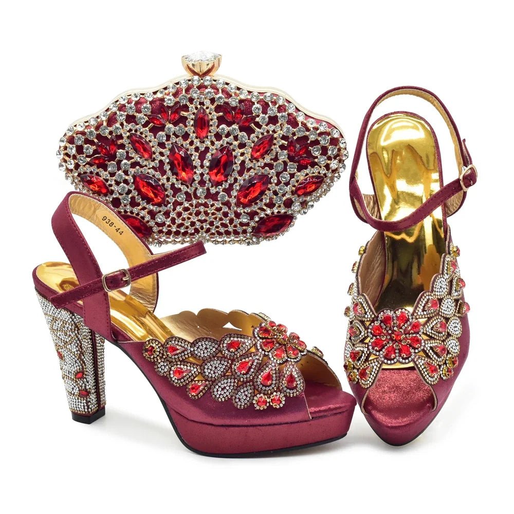 Pair of m high-heeled shoes with gold and red gemstones and a matching clutch on a white background.wine