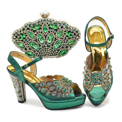 Green high-heeled shoes with detailed embellishments and a matching clutch on a white background