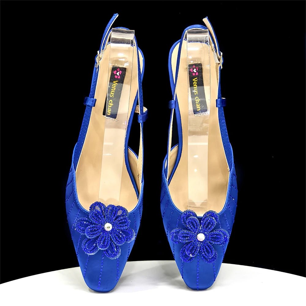 Pair of blue Italian Rhinestone Heels | Elegant Wedding with floral designs on a black background