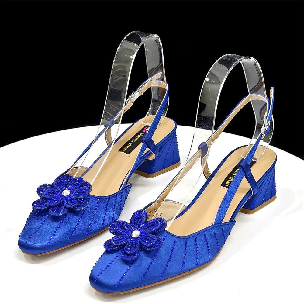 Pair of blue Italian Rhinestone Heels | Elegant Wedding, with floral embellishments on a white surface.