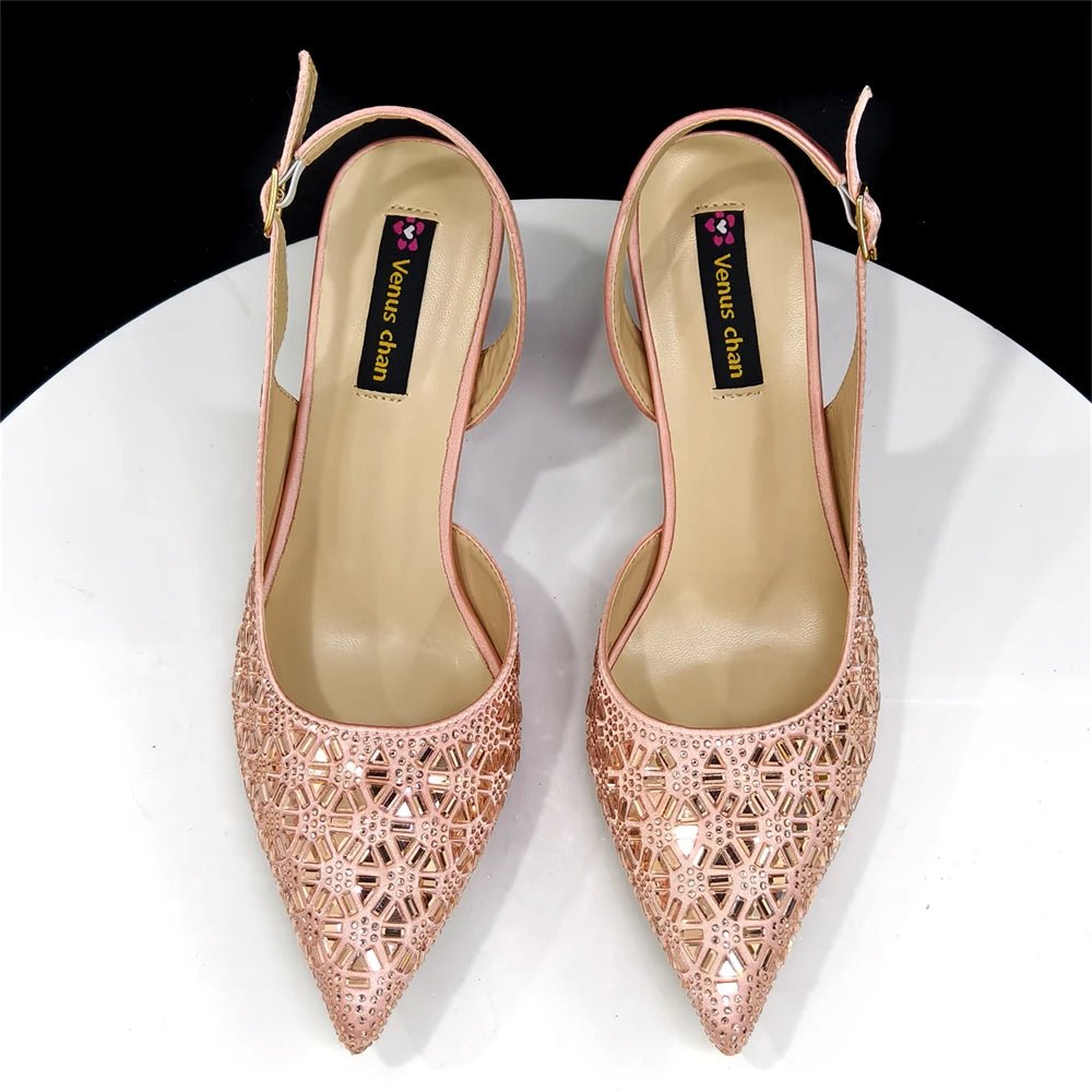 Pair of champagne pointed-toe Italian shoes with intricate designs on a white background
