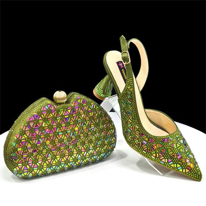 Green embellished high-heeled Italian shoes and matching clutch bag on a white surface with black background