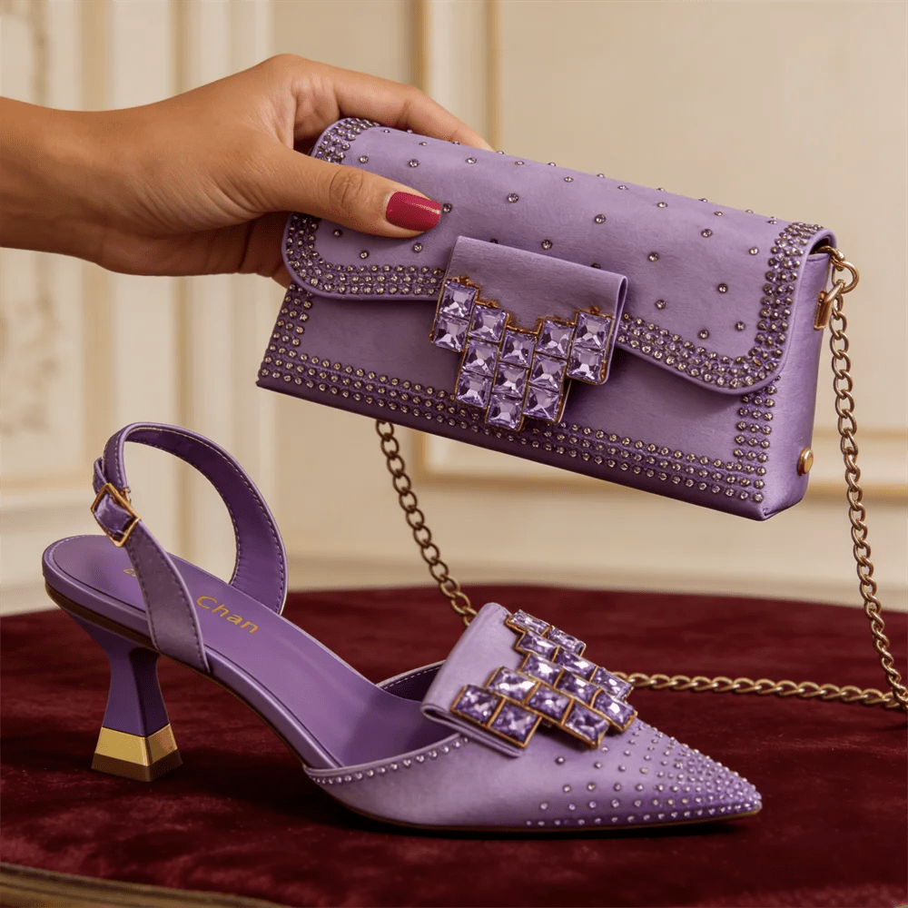 Taro Purple studded shoes and handbag on a red surface with a neutral background