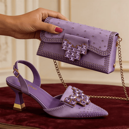 Taro Purple studded shoes and handbag on a red surface with a neutral background
