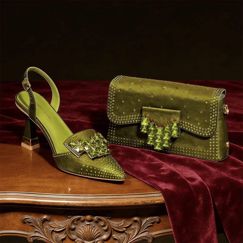 Olive Green high-heeled shoe and matching handbag on a wooden table with a dark background