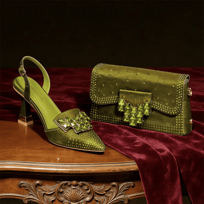 Olive Green high-heeled shoe and matching handbag on a wooden table with a dark background