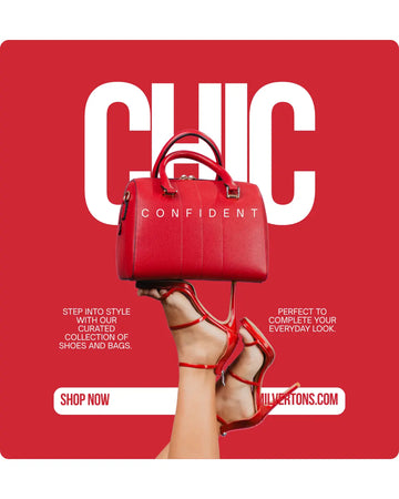 Model wearing a red coat and black hat, holding a book with a cityscape background, and standing in front of a fashion boutique.