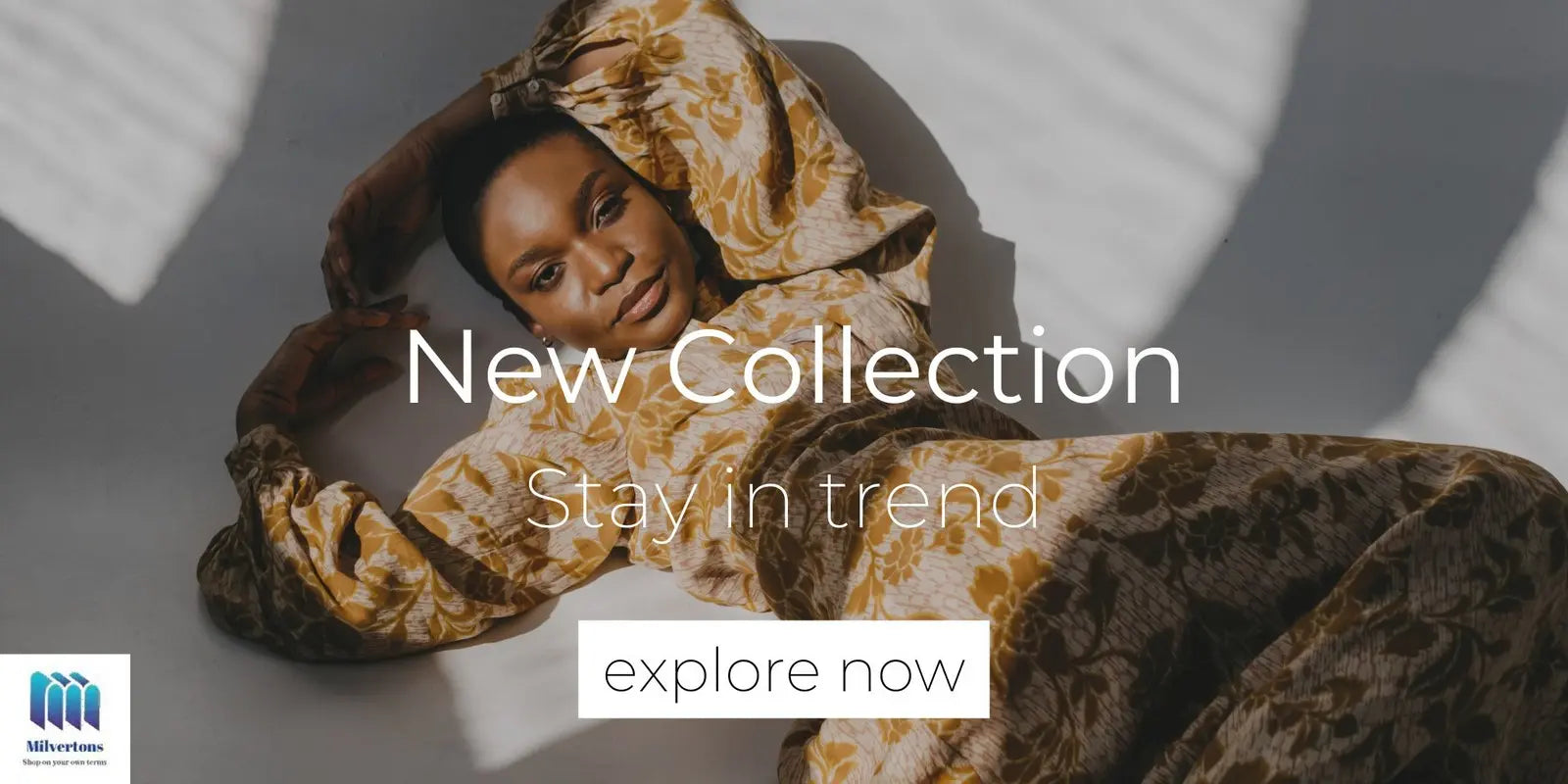 Woman in patterned dress with text 'New Collection, Stay in trend, explore now' on a gray background