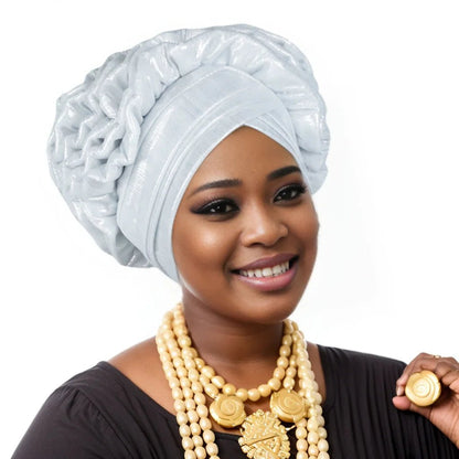 Woman wearing a white Nigerian auto gele headwrap on a white background