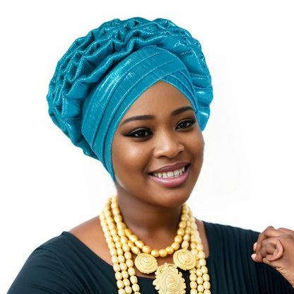 Woman wearing a lake blue Nigerian auto gele headwrap on a white background