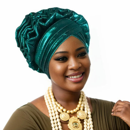 Woman wearing a green Nigerian auto gele headwrap on a white background