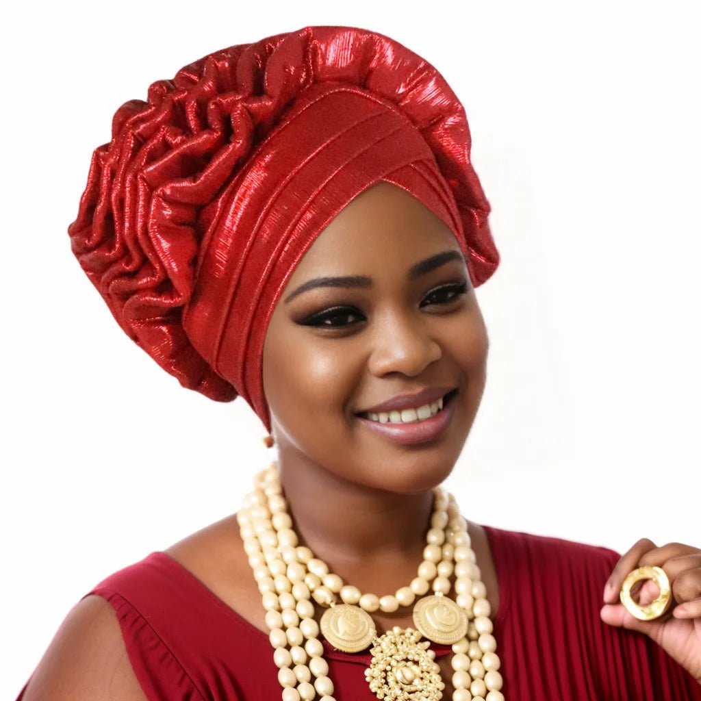 Woman wearing a red Nigerian auto gele headwrap on a white background