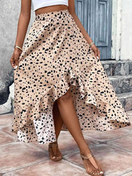 Woman wearing a light apricot skirt with black spots against a neutral background