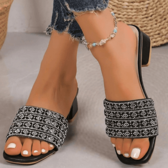 Black Rhinestone Open Toe Block Heels Sandals worn with denim pants on a neutral background