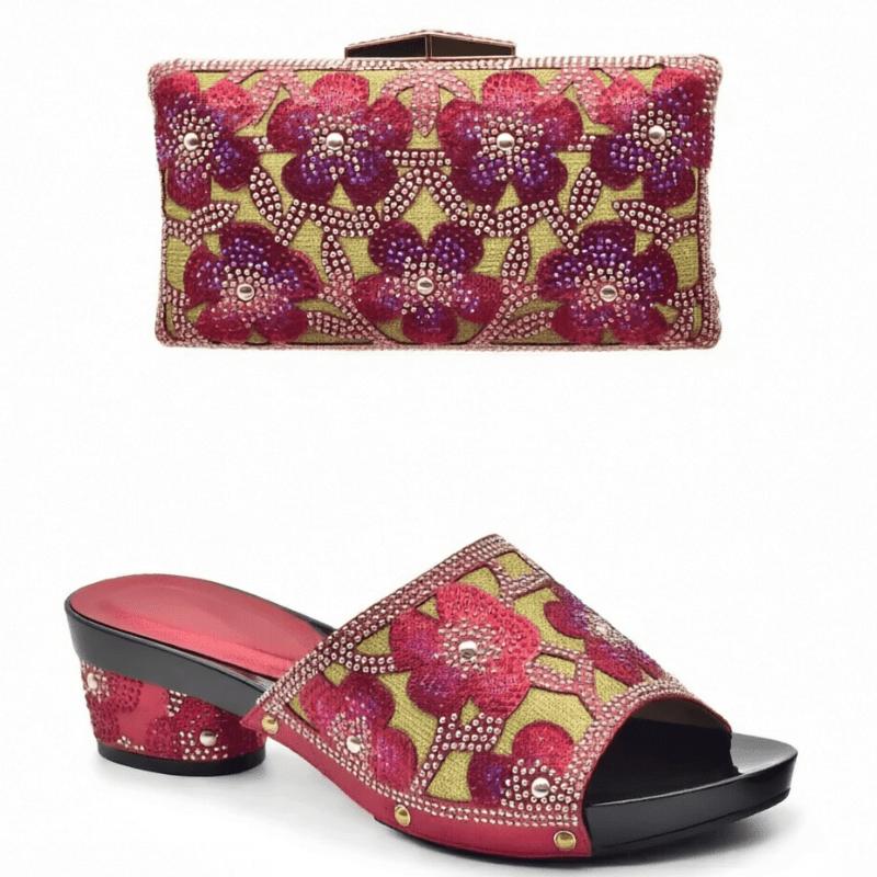 Pair of red floral trendy Italian design slip-on shoes and matching bag on a white background