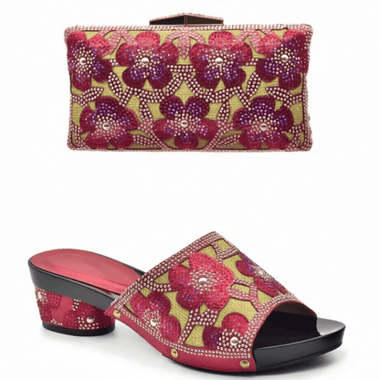 Pair of red floral trendy Italian design slip-on shoes and matching bag on a white background