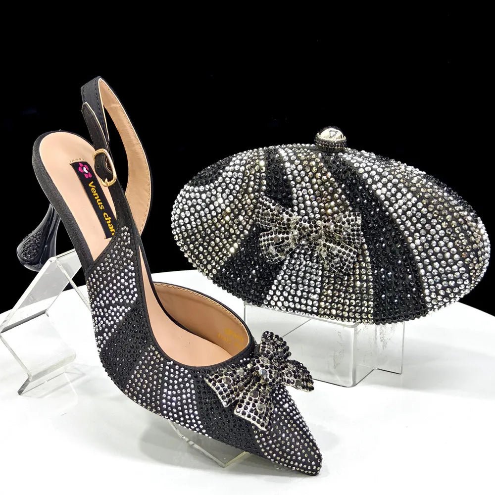 Black studded high-heeled shoes with a matching clutch on a clear stand against a black background