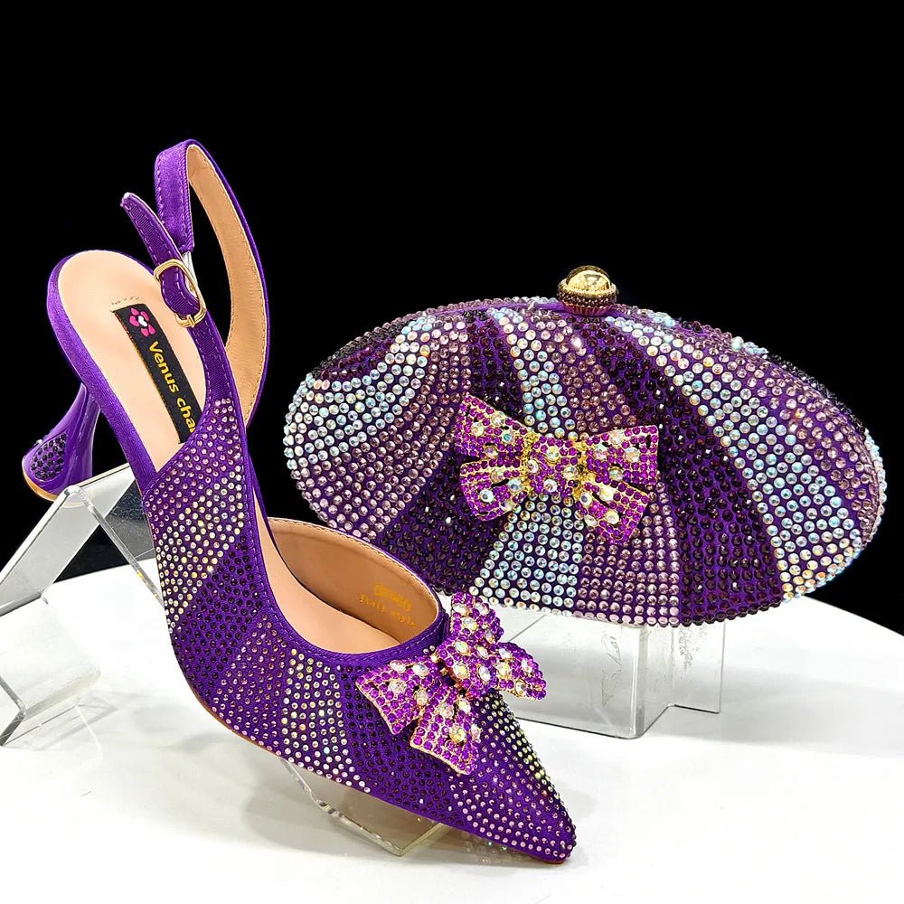 Purple high-heeled shoes with decorative bow and matching clutch bag on a clear stand.