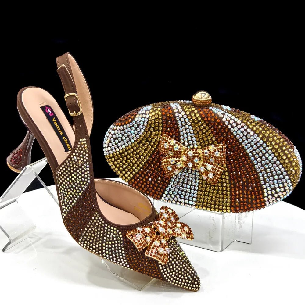 Brown studded high-heeled shoe with matching clutch on a clear stand against a black background